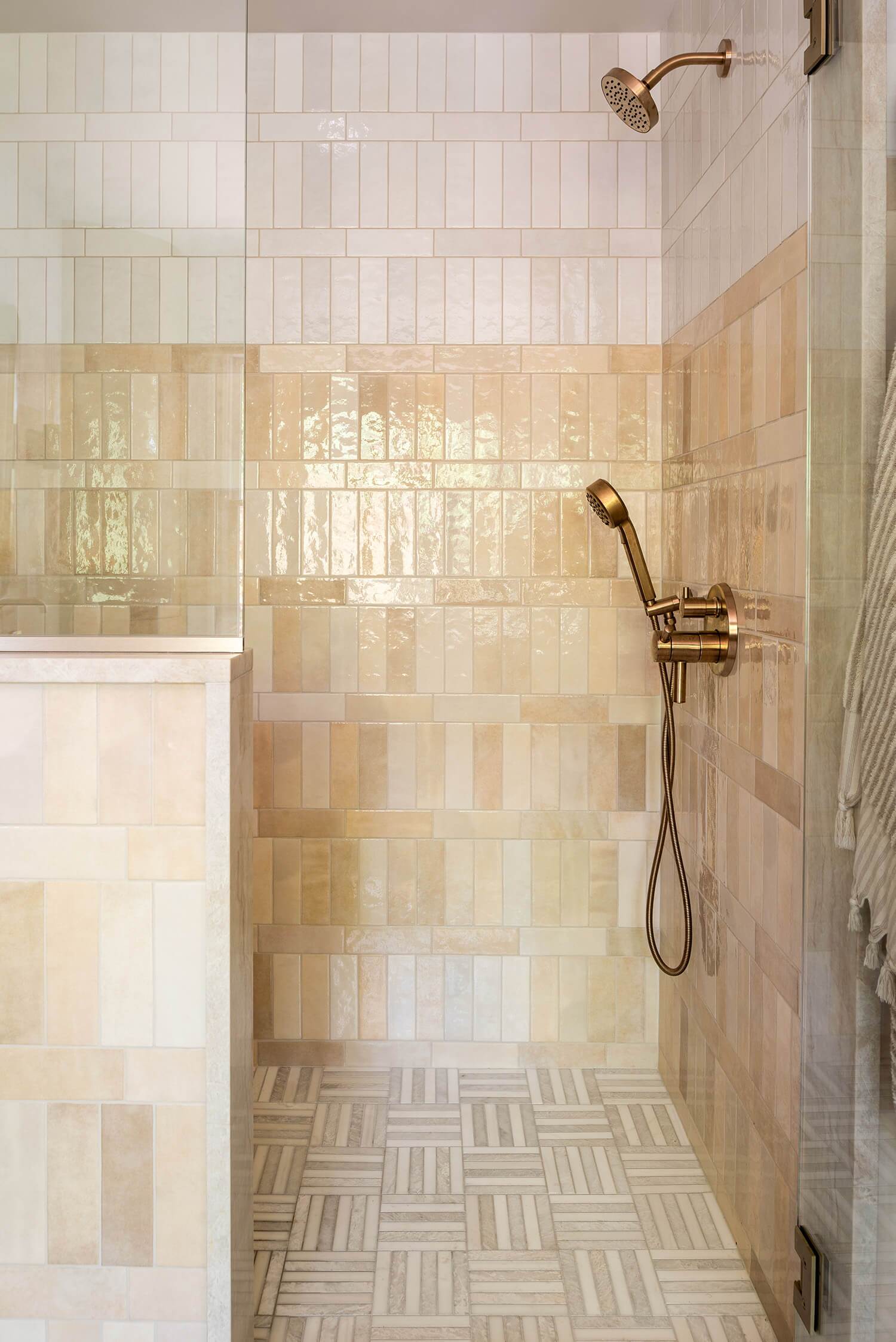 Bathroom detail with dark vanity, gold faucet, white counter, and mirror with black frame.