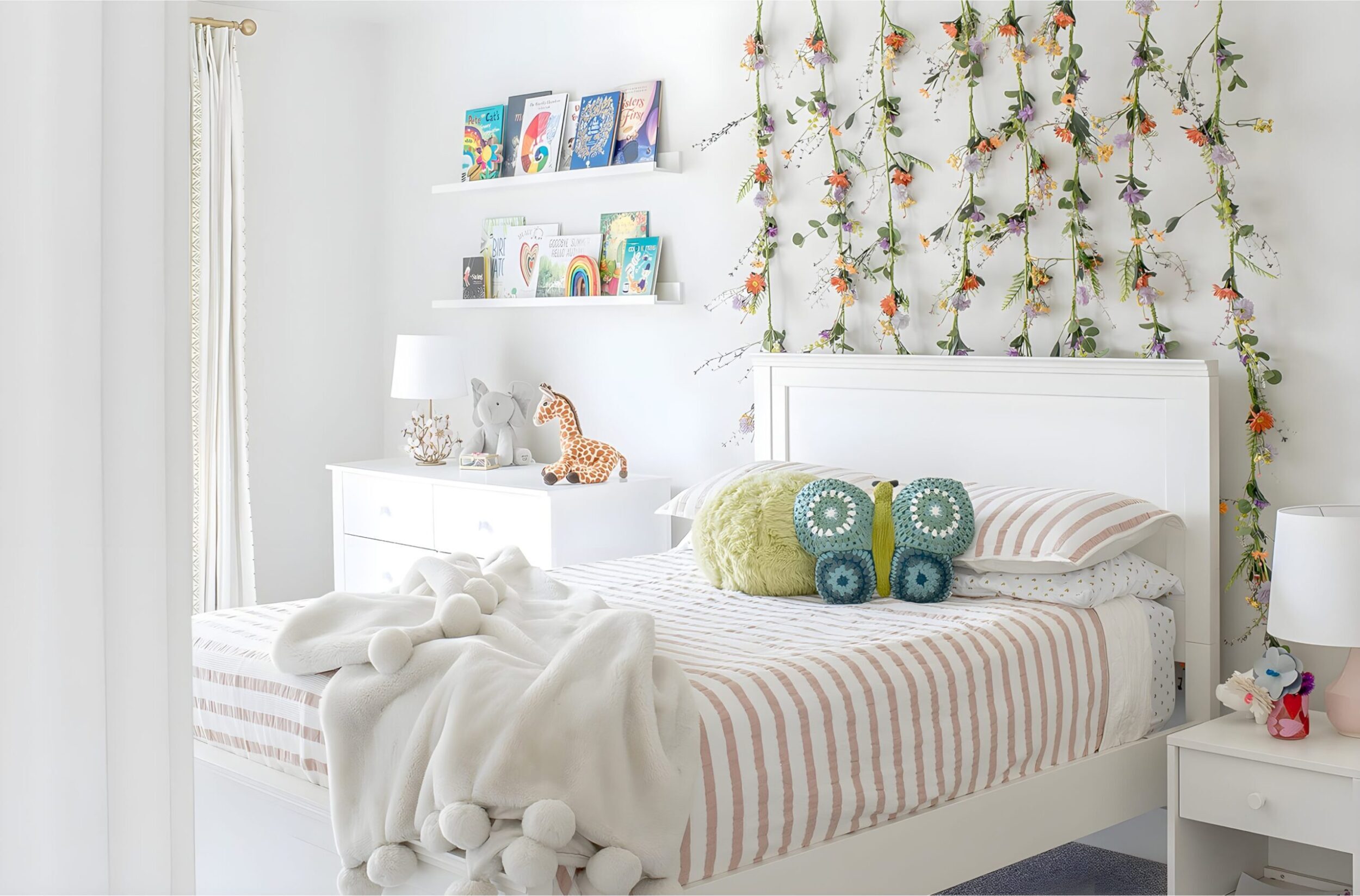 Girls’ bedroom with playful loft bed shaped like house, dotted wallpaper, baskets, and cozy reading nook