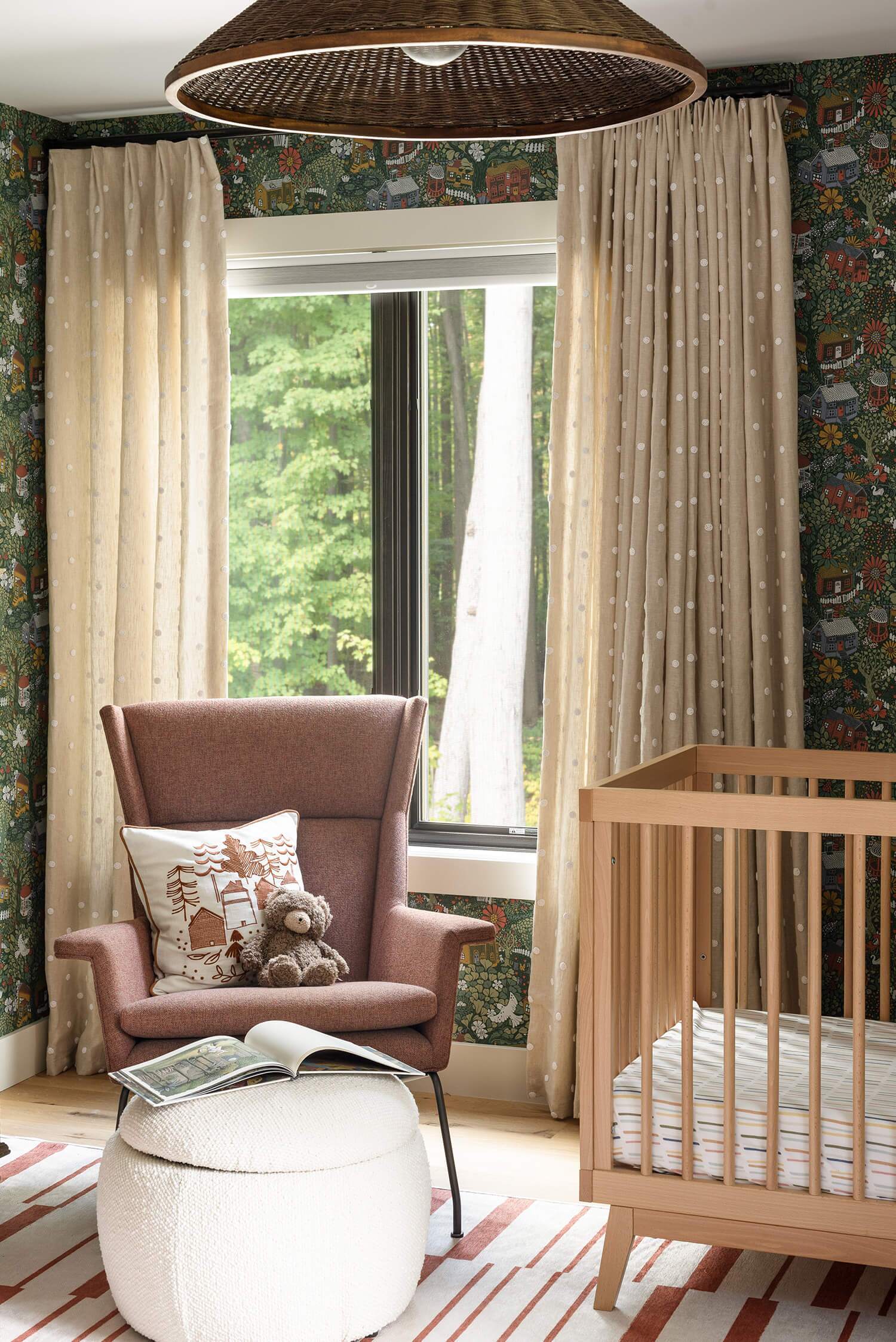 Cozy nursery corner: rust-colored armchair with patterned cushion and teddy, ottoman with book, wooden crib, polka-dot curtains.