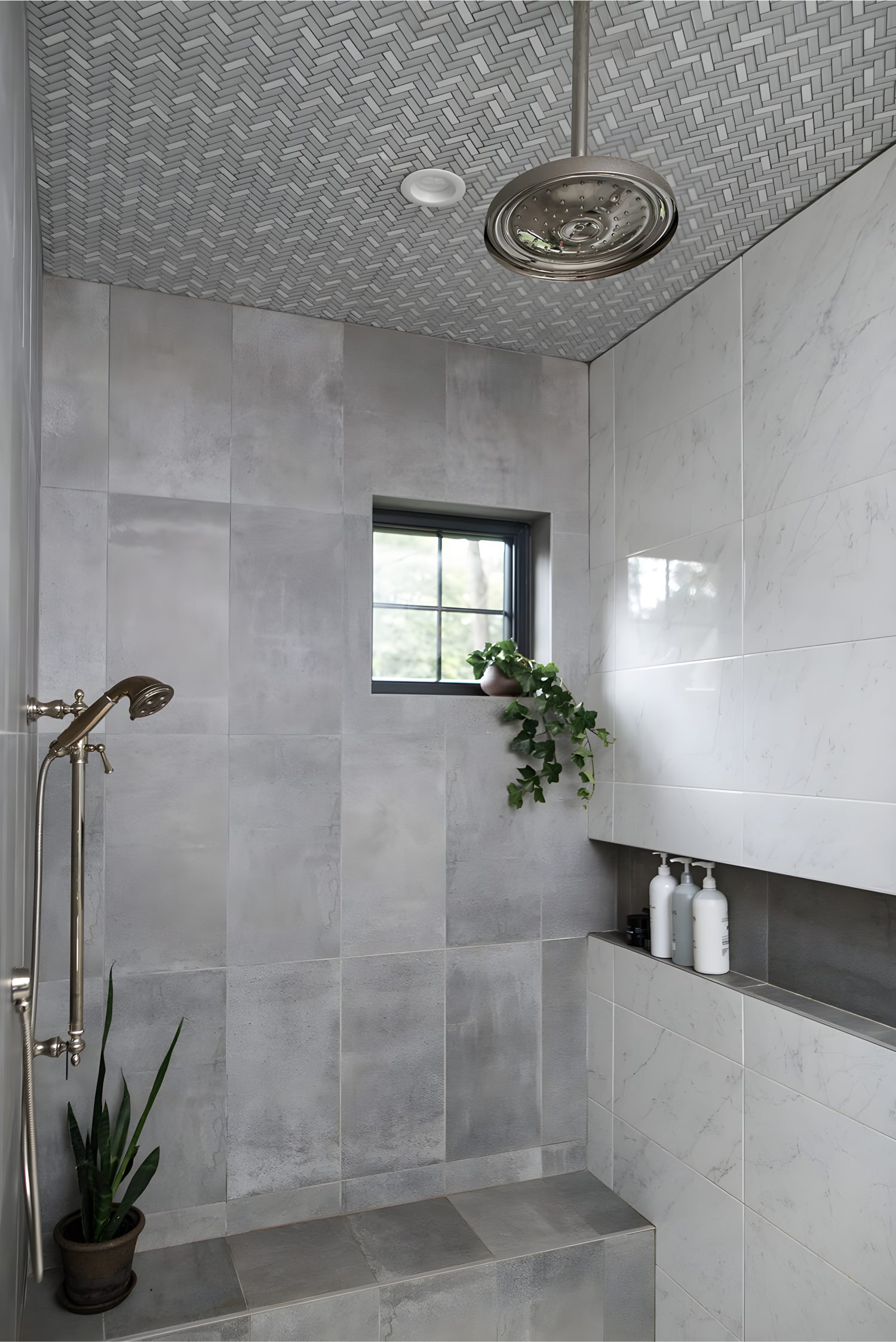 Gray tiled shower with rainfall head, marble accent wall, potted plants, and built-in shelf storage.