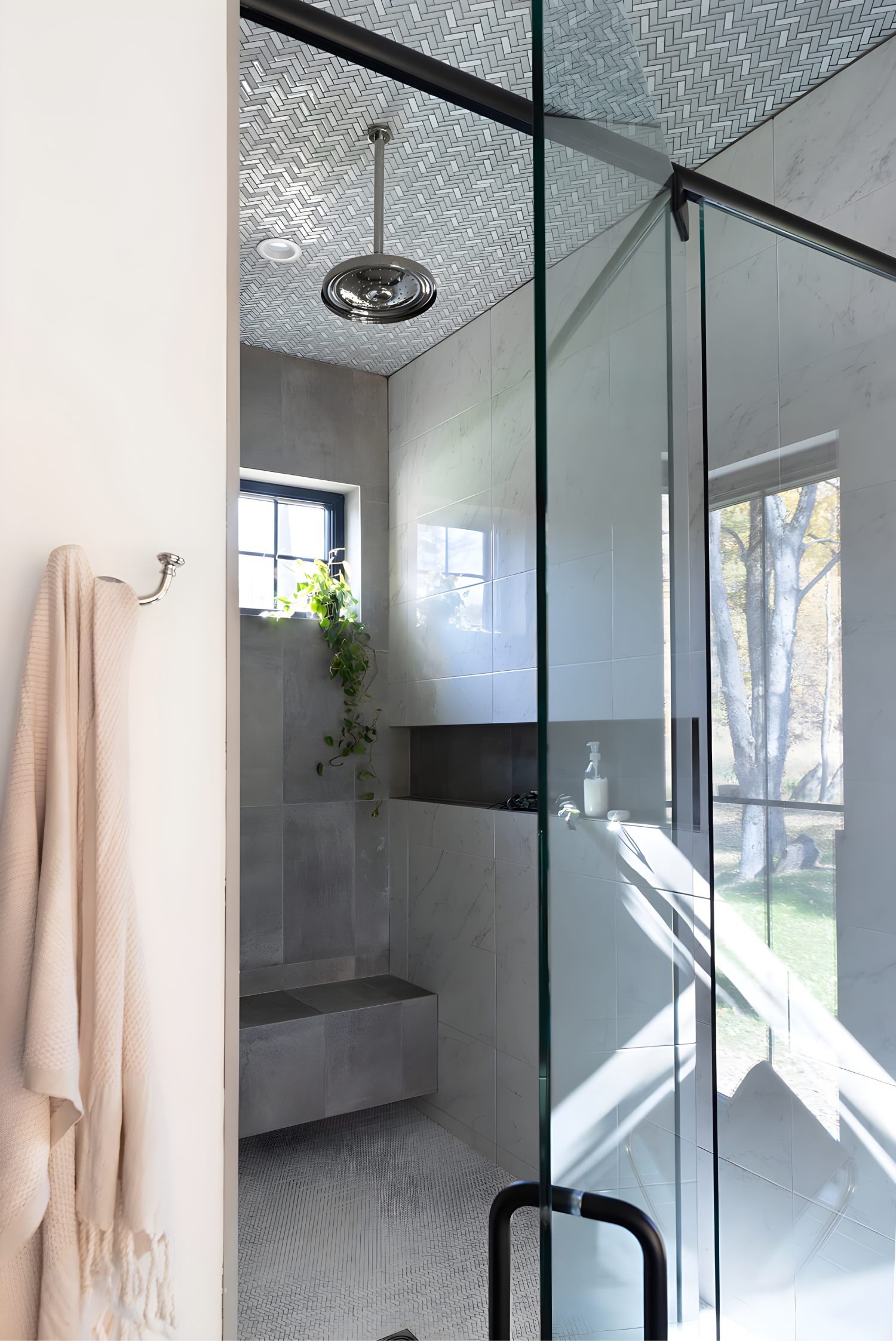 Modern vanity with clean cabinetry, dual mirrors, and fresh floral arrangements enhancing a sophisticated bathroom.