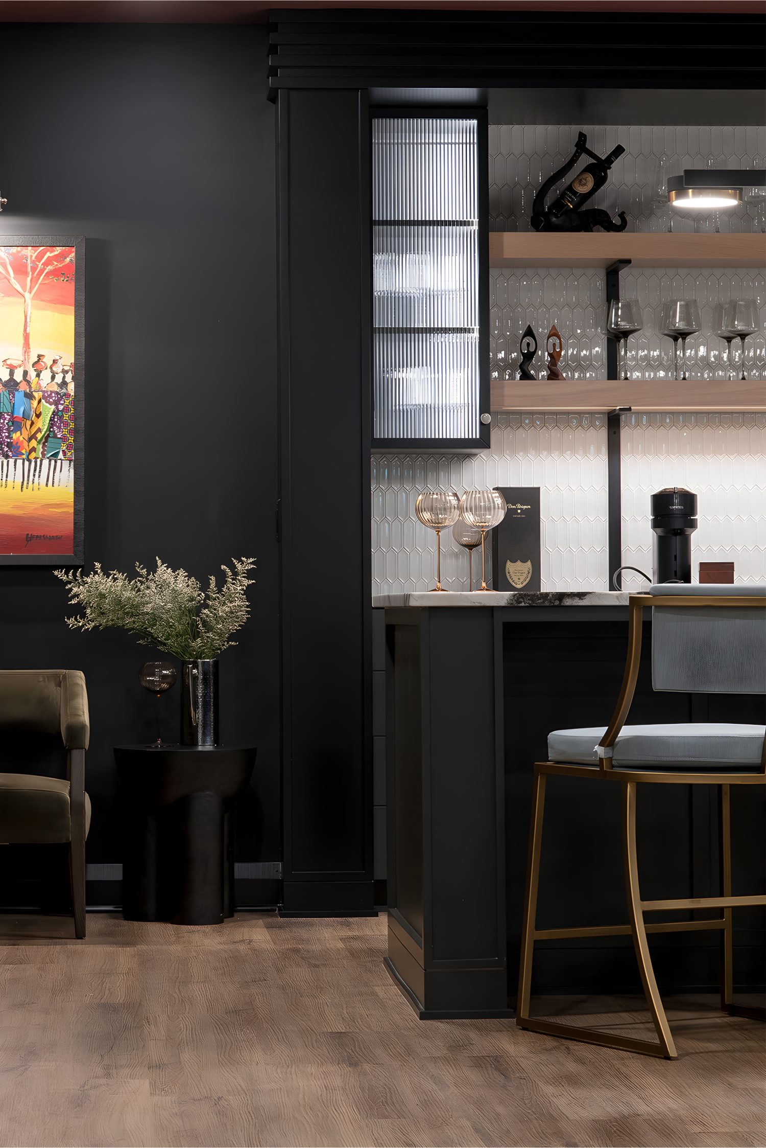 Chic home bar with dark cabinetry, open shelves, glassware, and accent lighting, styled with modern gold and black décor.
