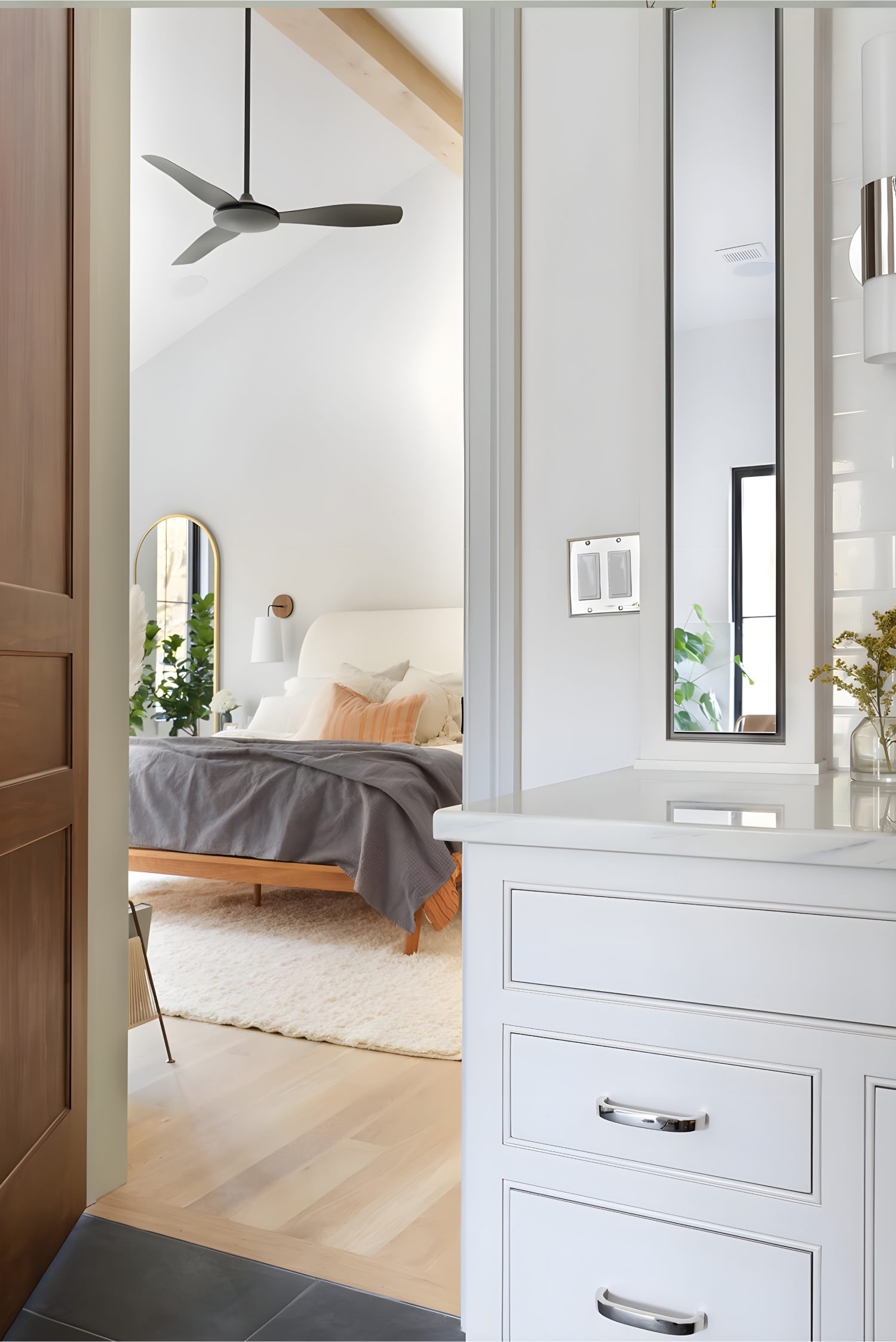 Minimalist bathroom with sleek vanity, framed mirror, and decorative shelves featuring dried lavender in glass.