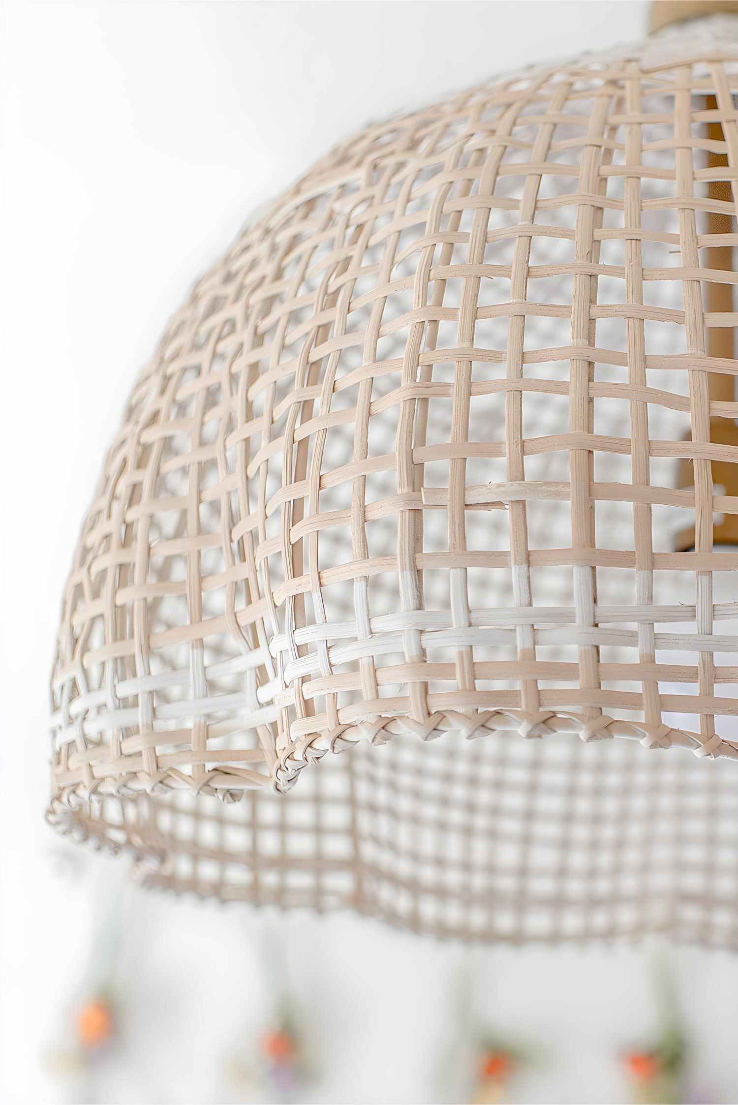 Woven rattan pendant light close-up, showing natural texture in bright white kids’ room interior