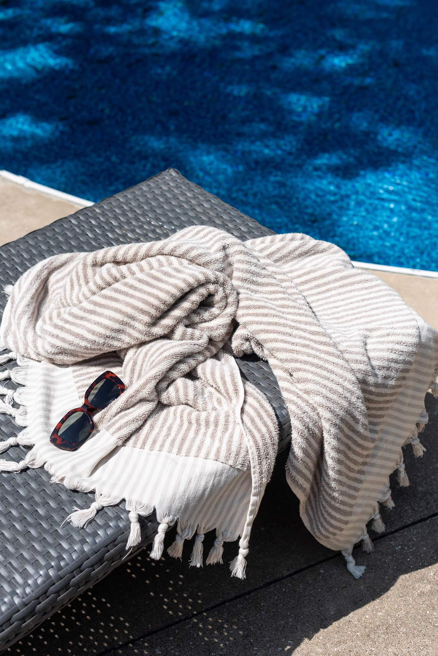 Modern living room with sage green built-in shelves, contemporary armchair, and fireplace framed by decorative accents.