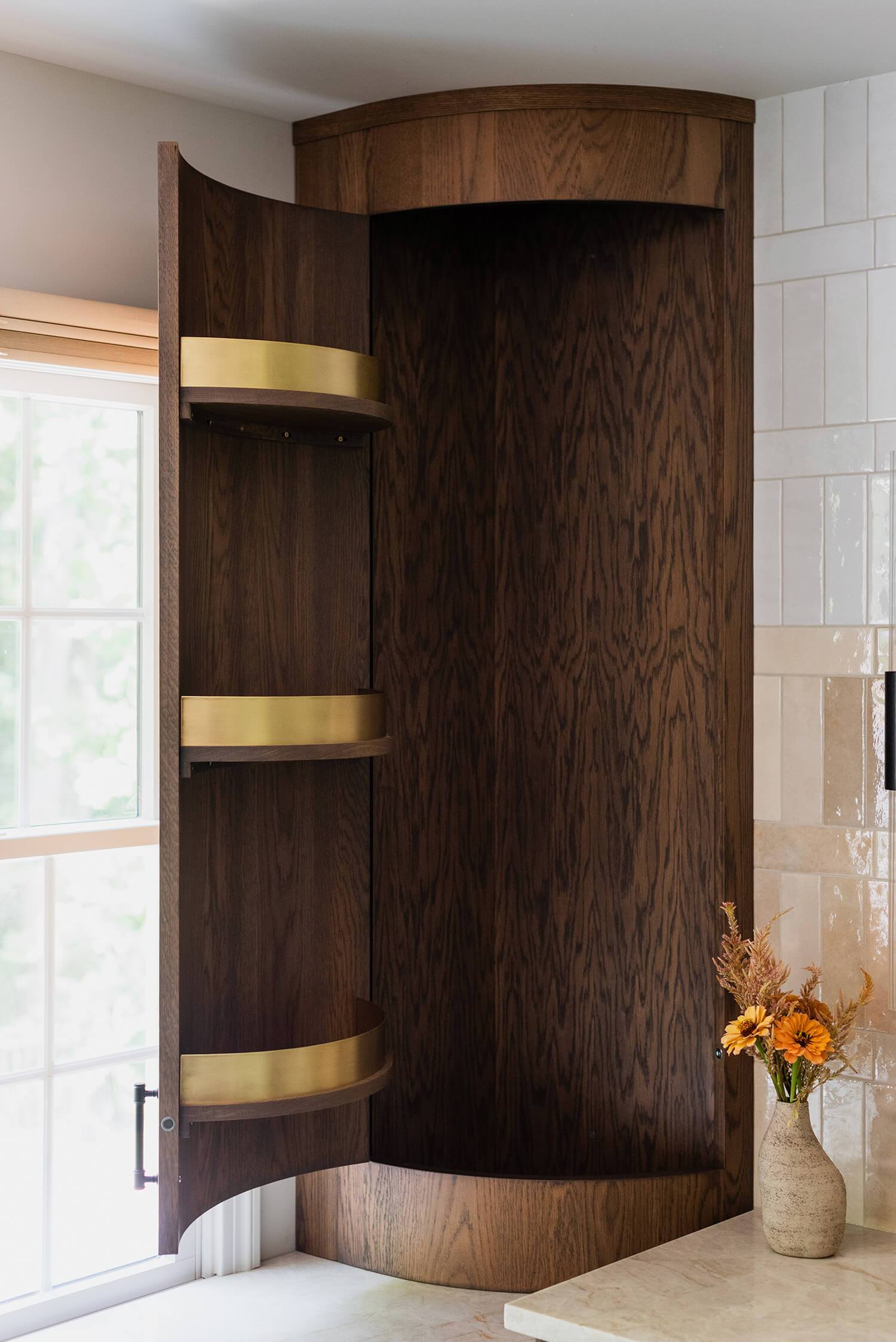 Kitchen close-up with white subway tile backsplash, dark cabinets, and open wood shelving.