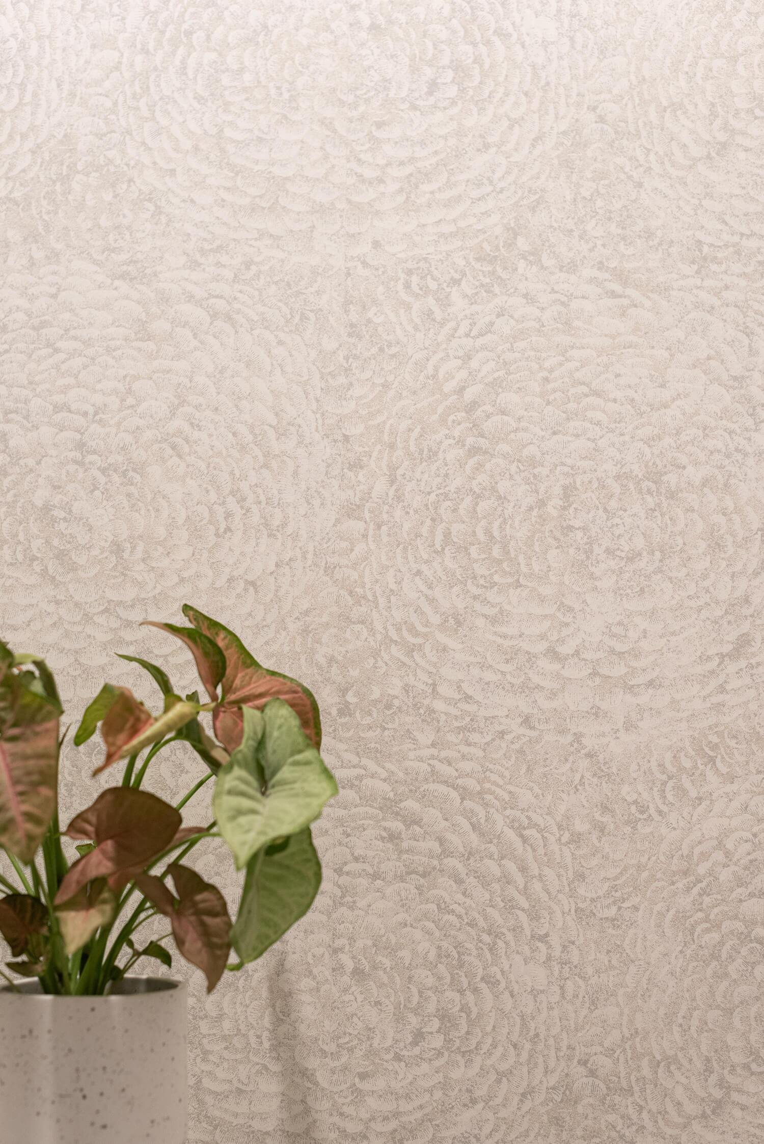 Subtle textured wallpaper in neutral tones with potted plant adding greenery to the elegant minimalist design